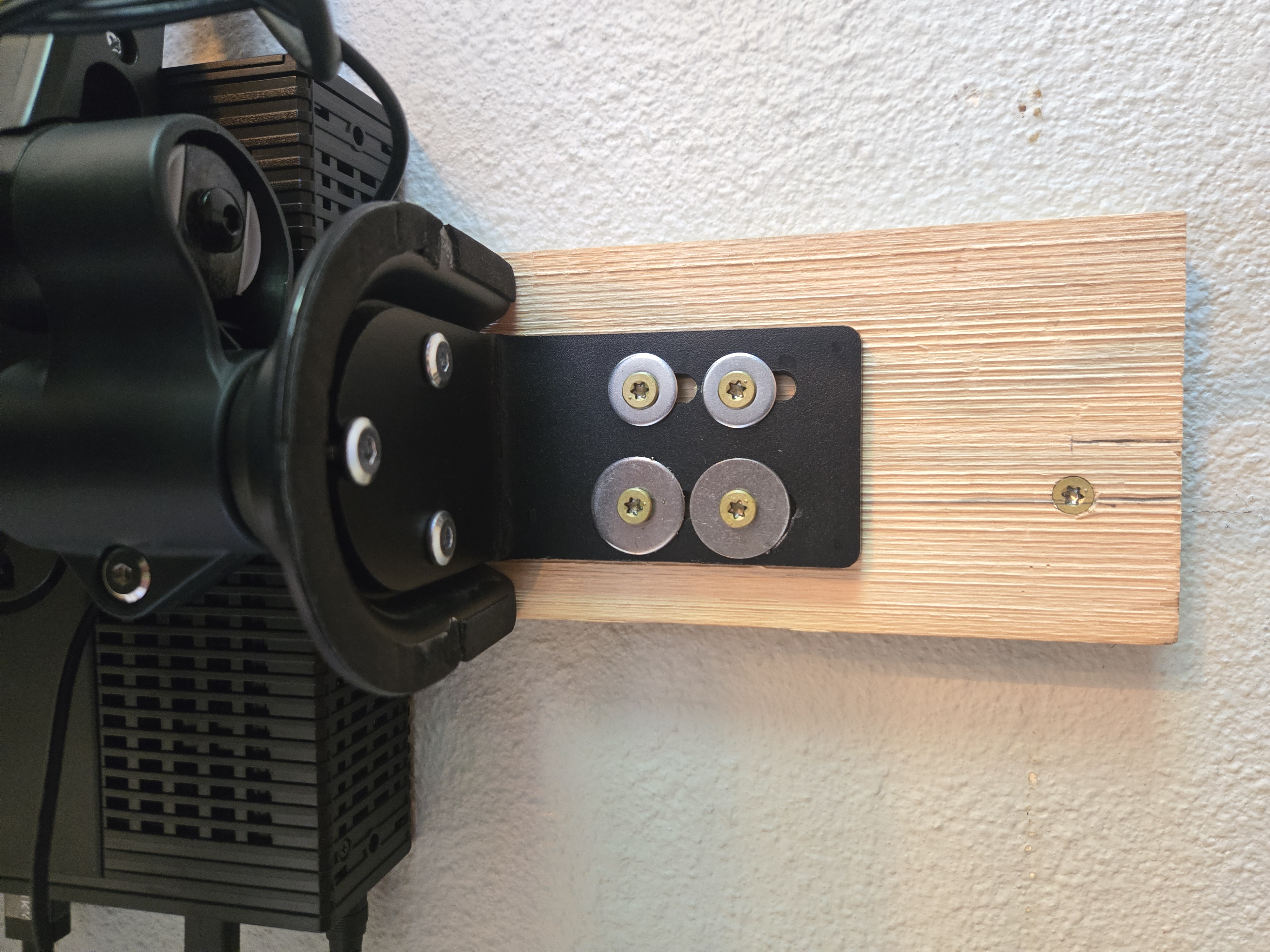 The arm's base plate screwed into the common board and studs
